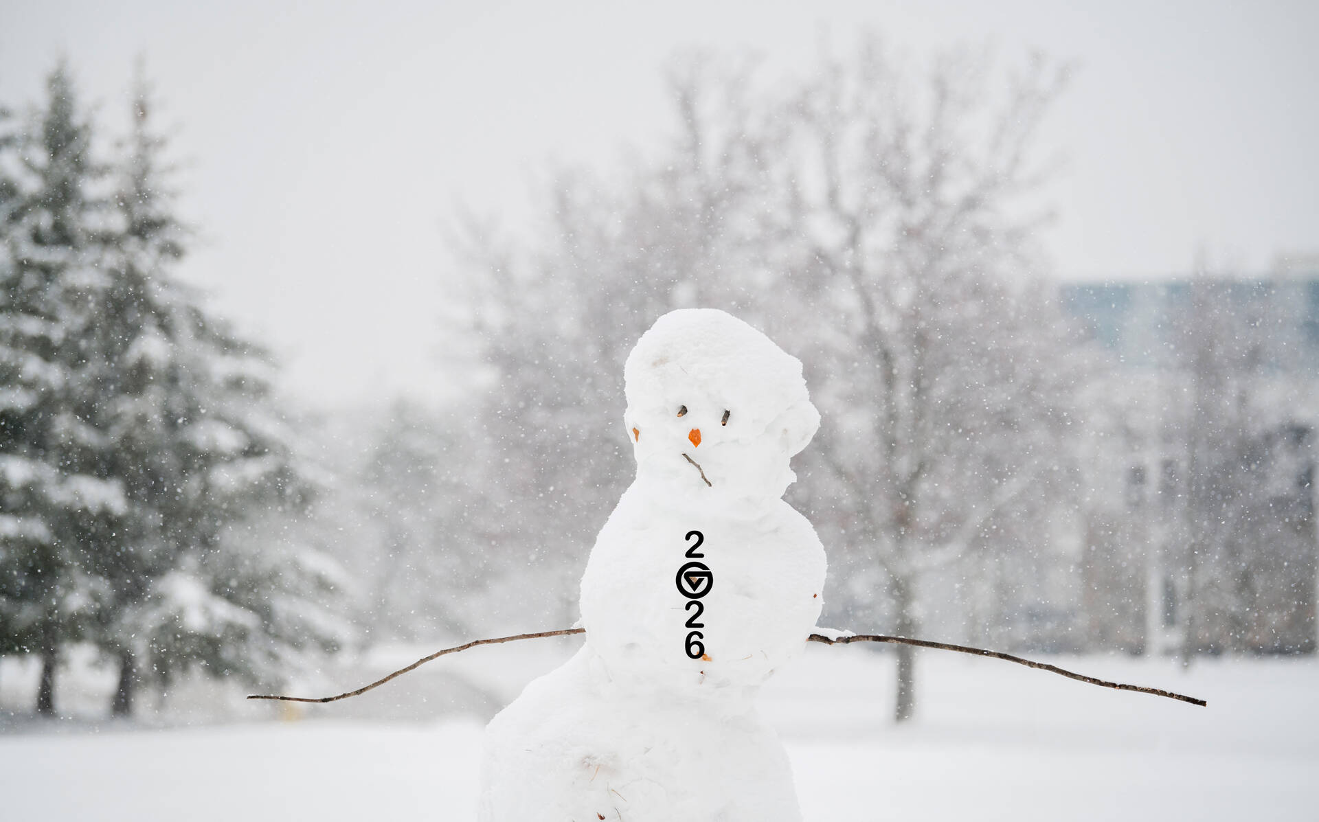 Snowman on GVSU campus with buttons down the front in shape of 2026.
